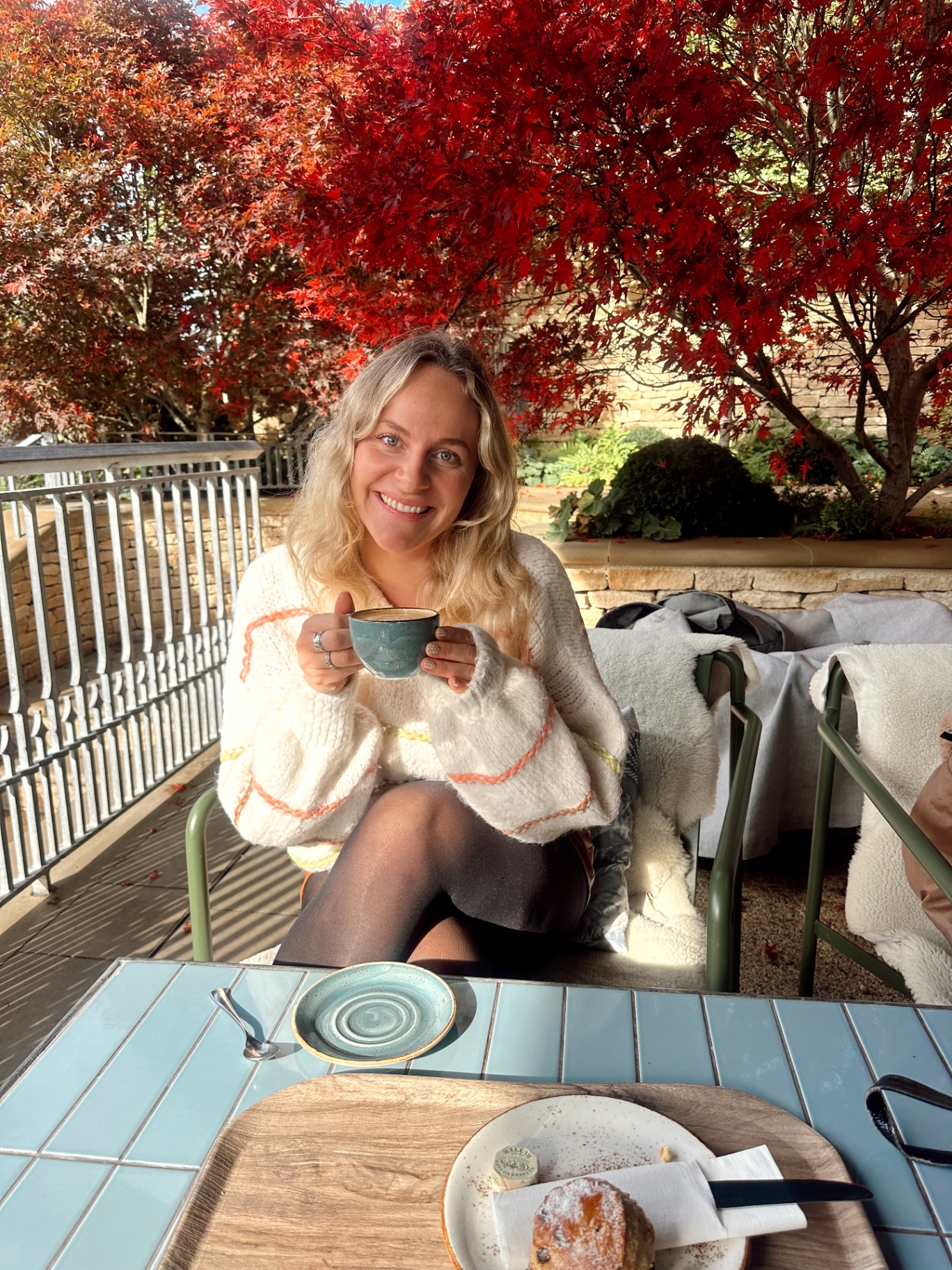 A cup of coffee held in autumn light