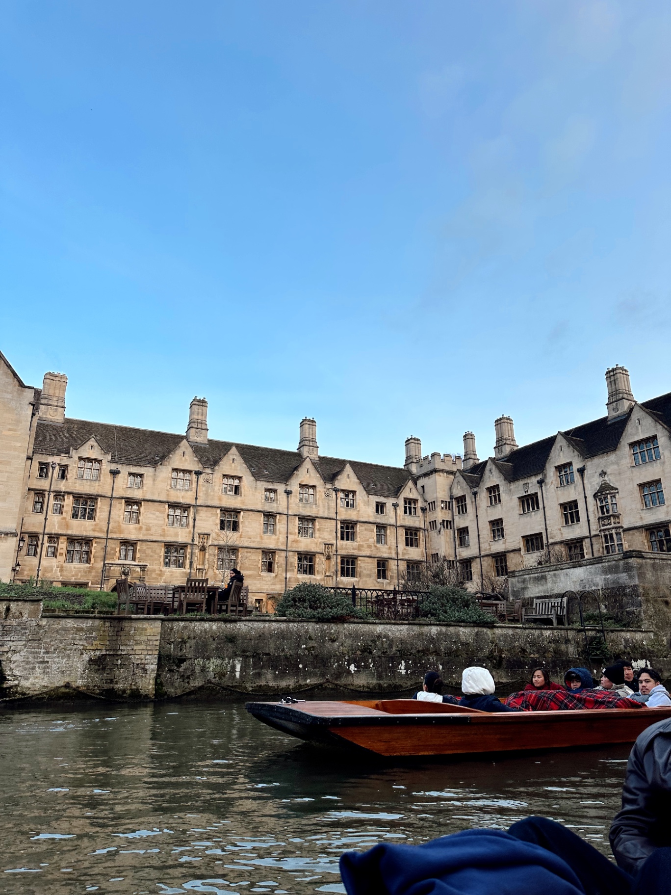 Punting past a Cambridge college on the river