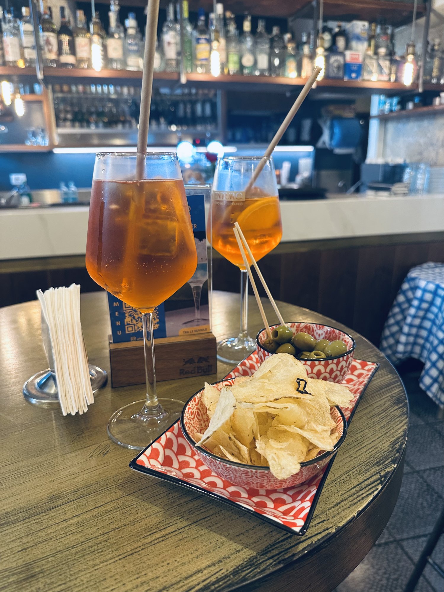 An Aperol spritz on a sunny table outside a European bar